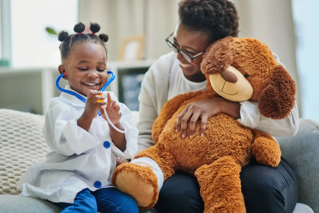 pediatric child with mother and big teddy bear