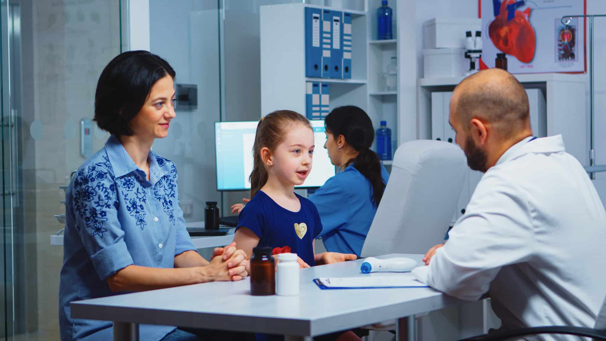 Doctor giving high five with little patient in medical office.